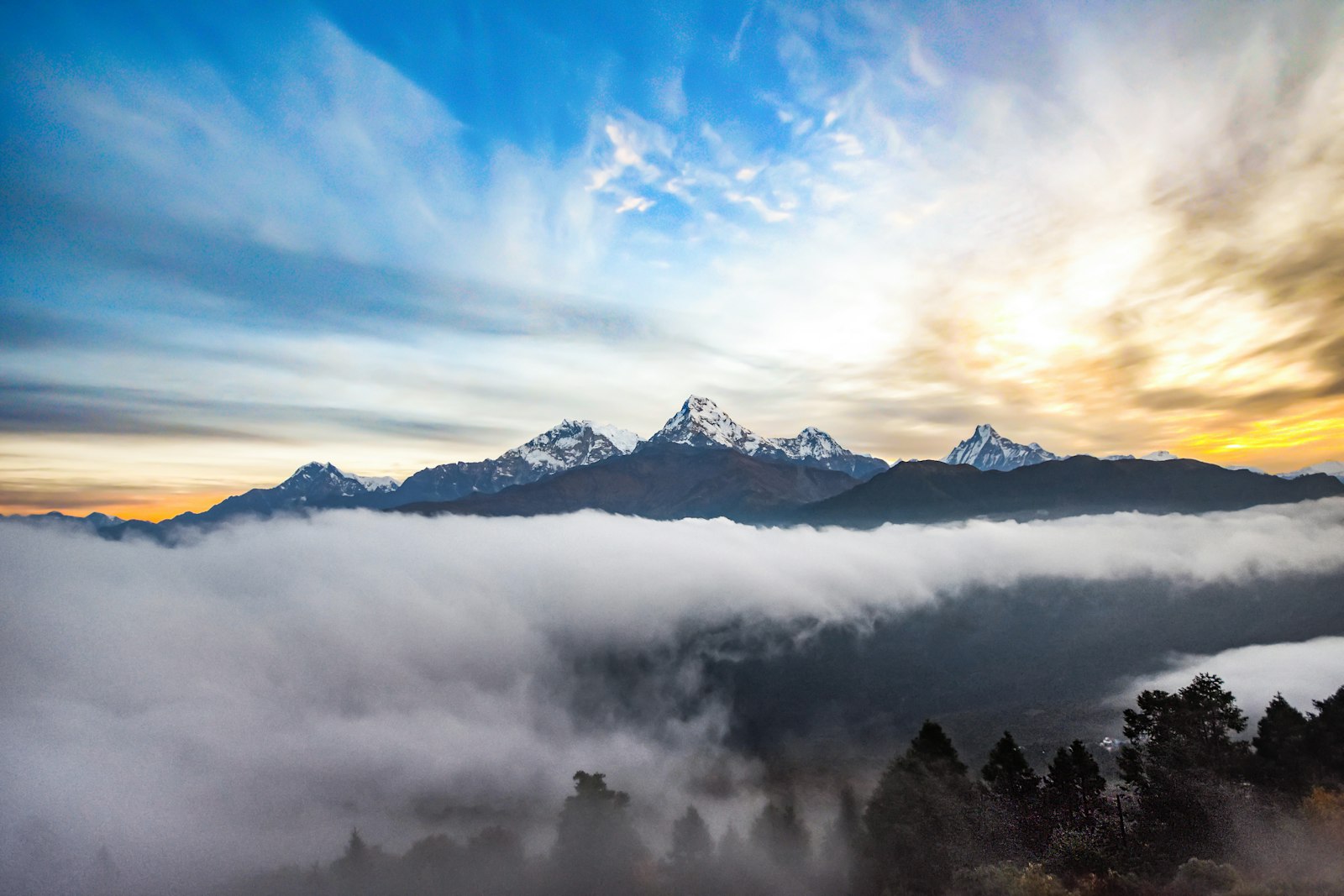 Sunrise above a sea of cloud with Annapurna peaks and Machhapuchhre
