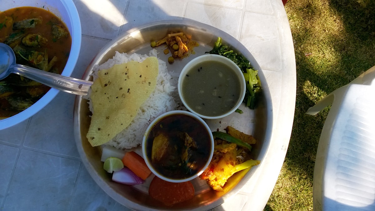 A Nepali thali platter with rice, dal, curry and sides — representative image; swap for a real photo of Honacha, Patan.