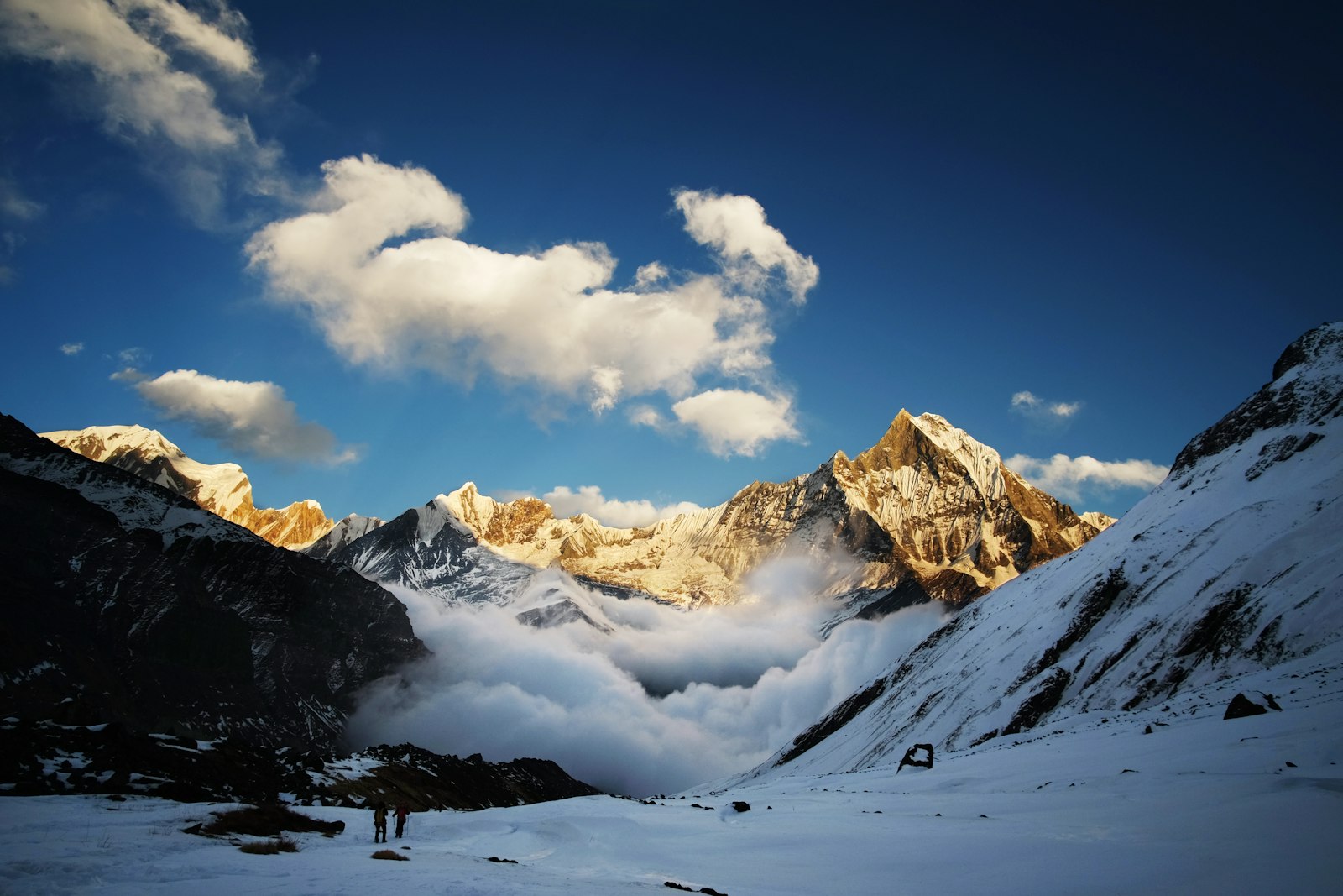 Snowy Annapurna Sanctuary amphitheatre with Machhapuchhre and trekkers